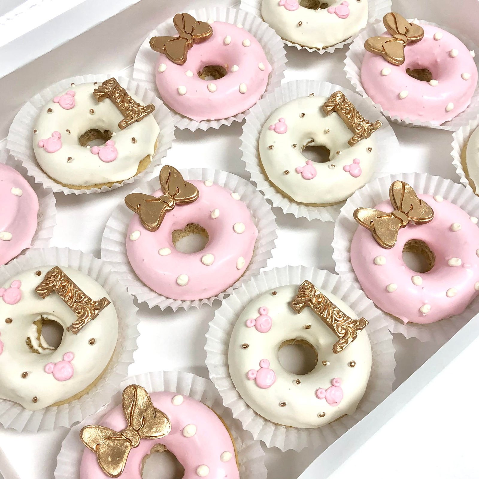 Baked donuts finished with glaze and gold decorations