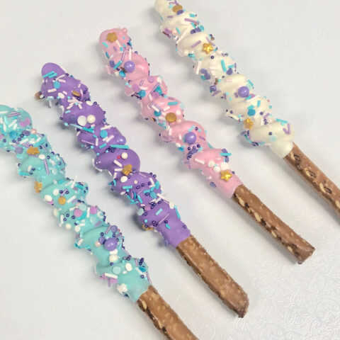 Chocolate dipped pretzel rods decorated with sprinkles